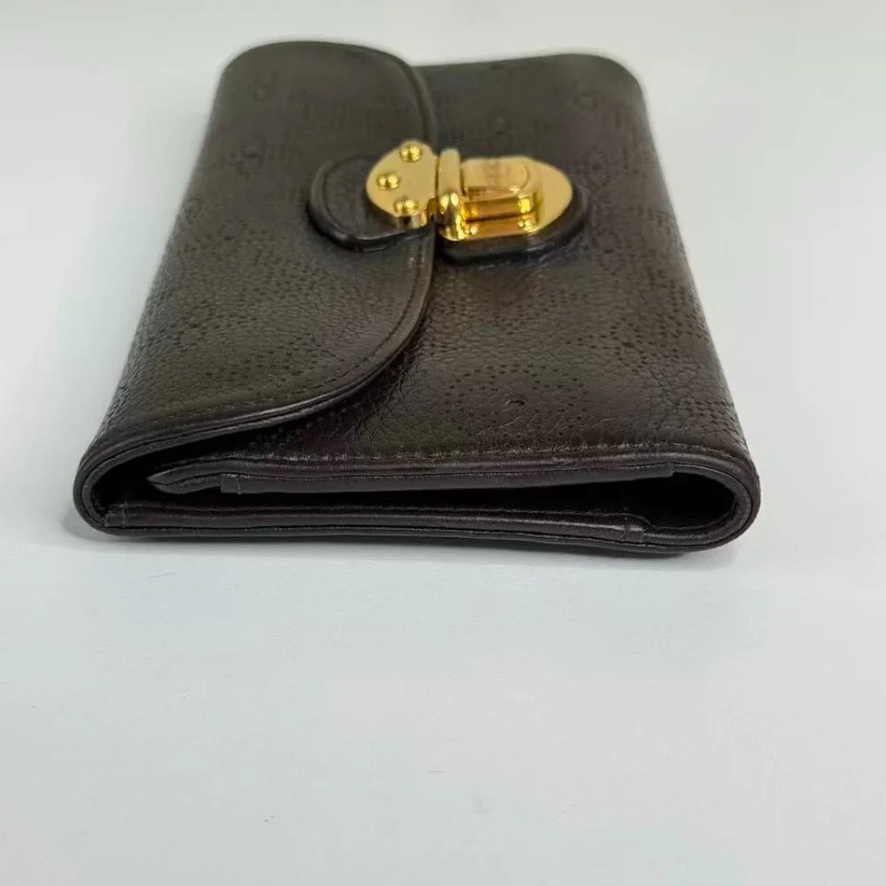 Louis Vuitton Black Monogram Canvas Wallet with Gold Hinge Detail Elegant Design
